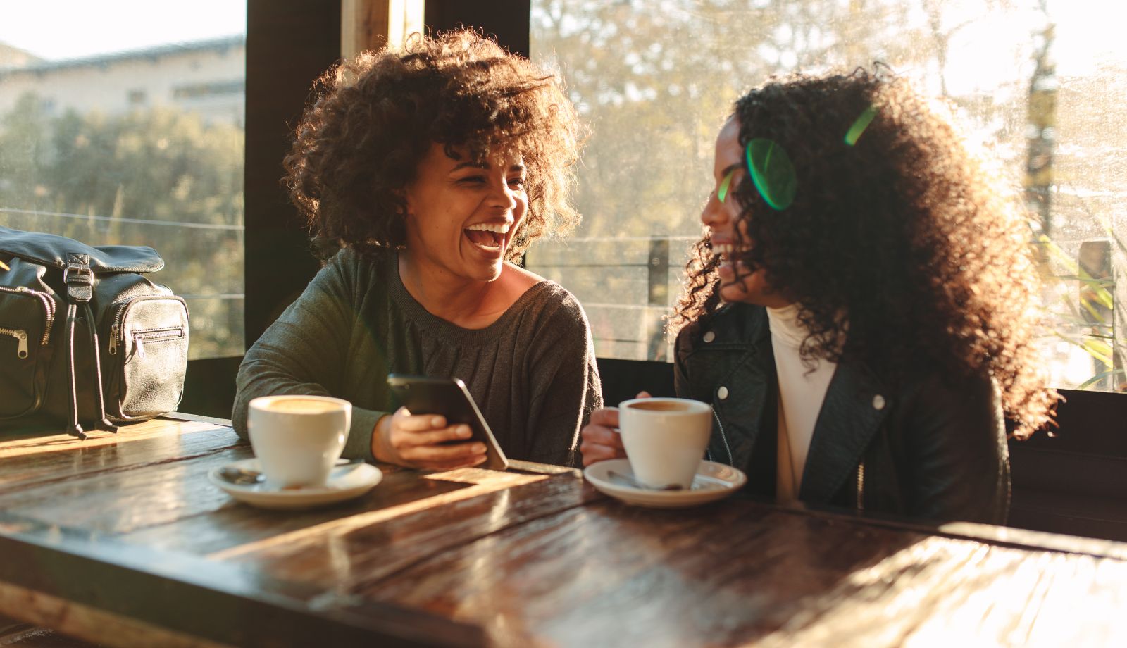 two women drinking coffee and a cafe