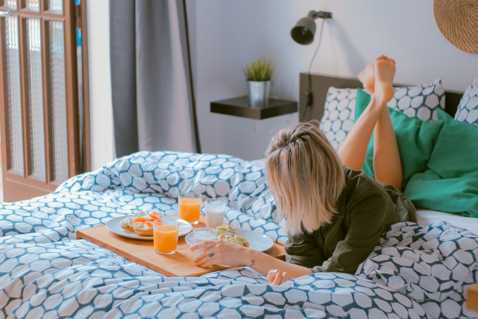 resident laying on bed eating breakfast